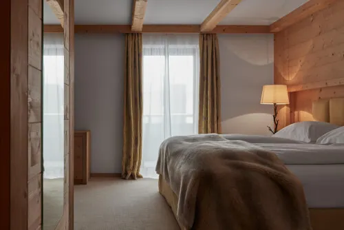 Elegant room featuring a double bed, stylish bedding, and soft lighting at TOP Hotel Hochgurgl