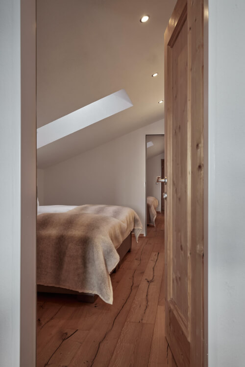 Spacious bedroom designed for 2-6 guests with 3 double beds, wood flooring at TOP Hotel Hochgurgl