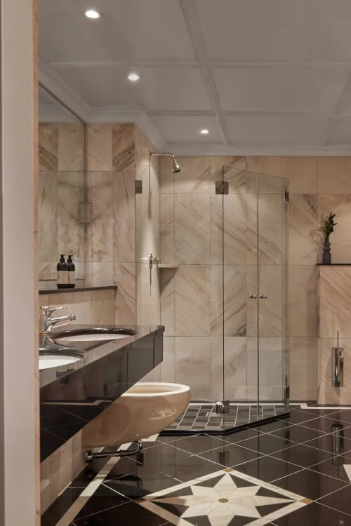Bathroom with glass shower door in TOP Hotel Hochgurgl, suitable for 2 guests