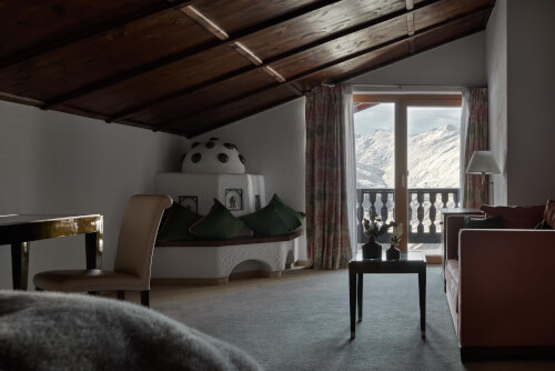 Spacious room with balcony, fireplace, and double bed, ideal for 3 guests at TOP Hotel Hochgurgl