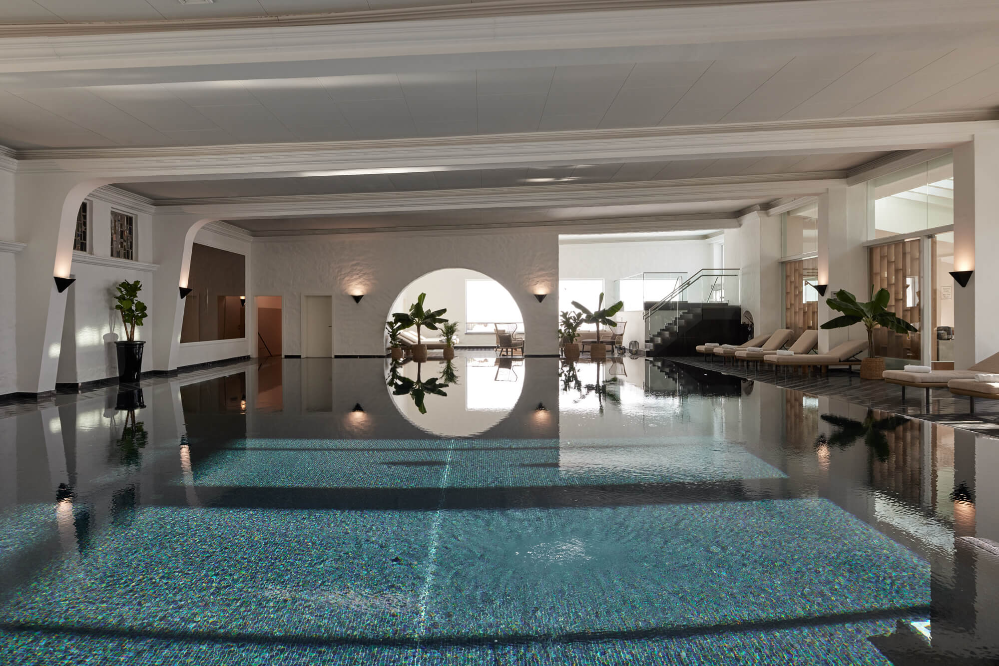 A swimming pool inside a building with SPA & Wellness facilities, treatment rooms, and a view of the