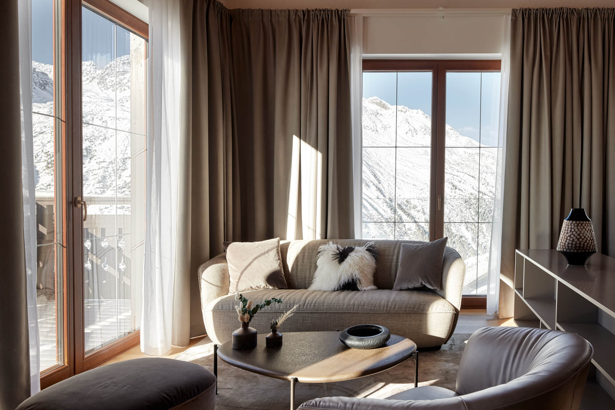 A living room with a couch and a coffee table in TOP Hotel Hochgurgl