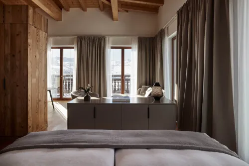 Spacious hotel room with a large table and chairs near a wide window, suitable for 2-3 guests at TOP Hotel Hochgurgl by Promontoria Hochgurgl GmbH